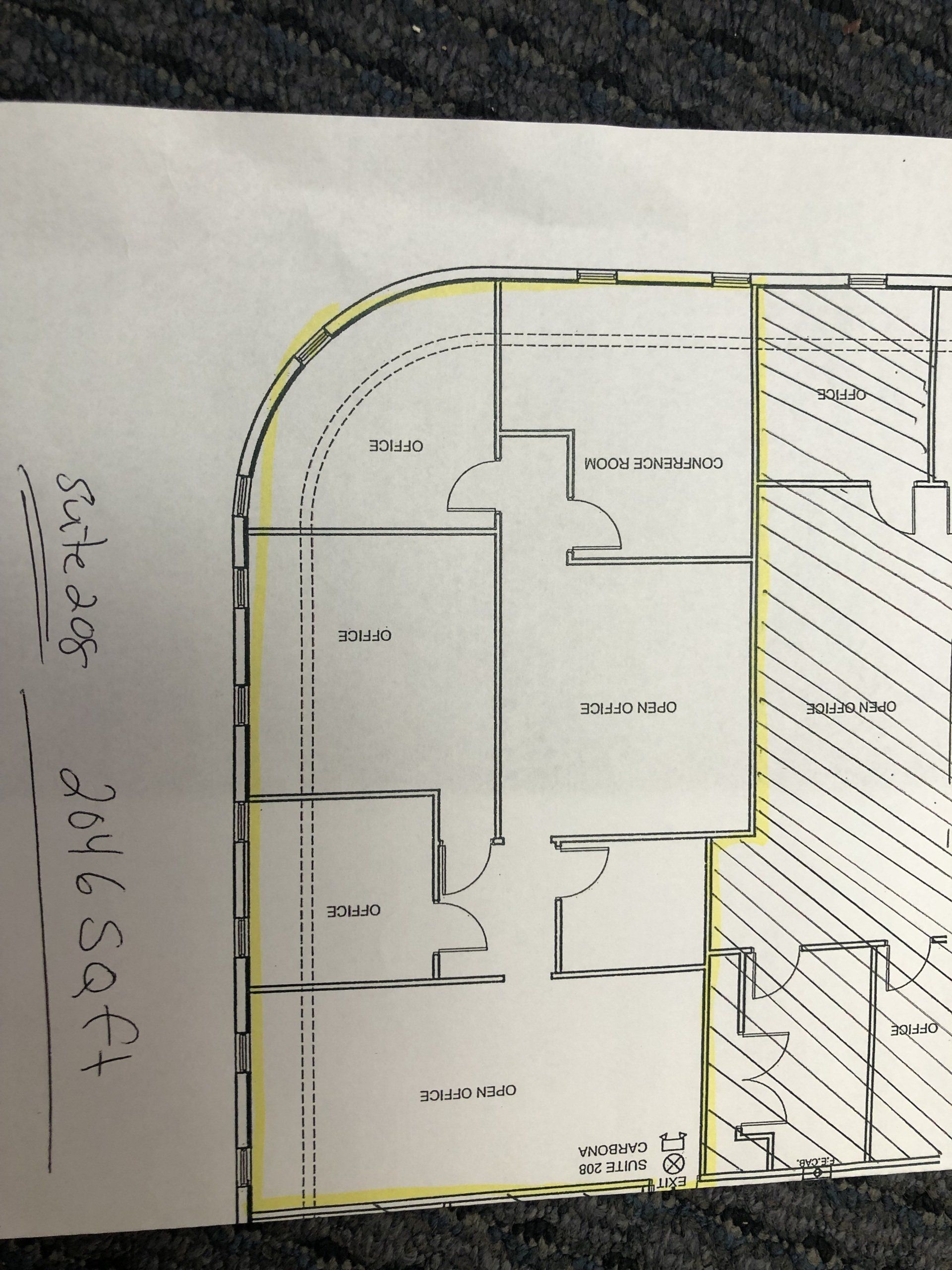 Floor plan of a building with multiple rooms. Curved exterior wall highlighted in yellow.