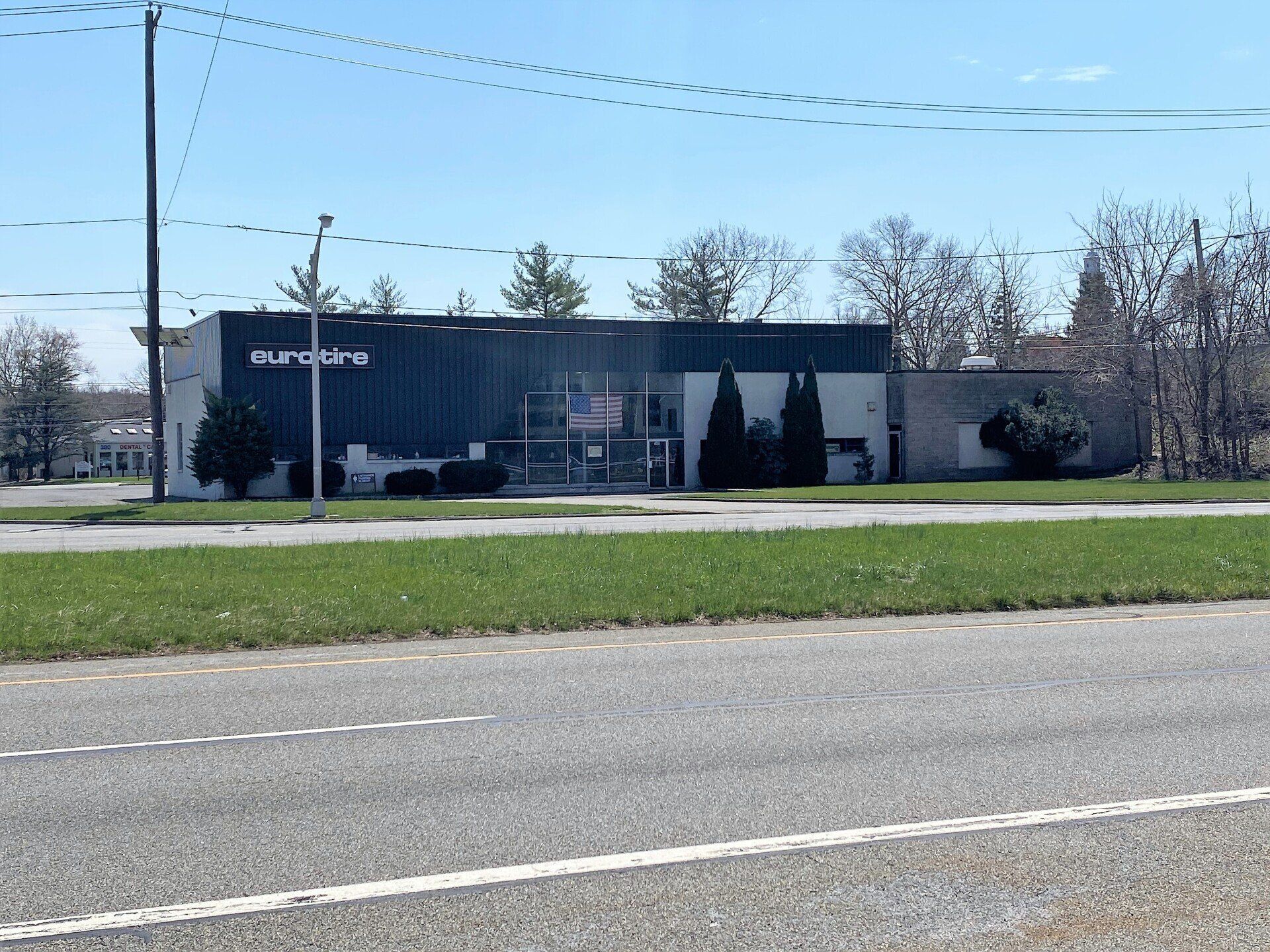 A commercial building with dark siding and 