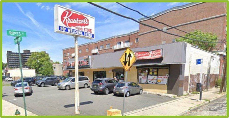 Kowalski's Food Town store exterior, sign, cars parked in front, and street intersection.