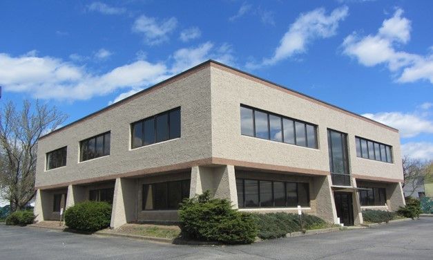 A large building with a lot of windows on a sunny day