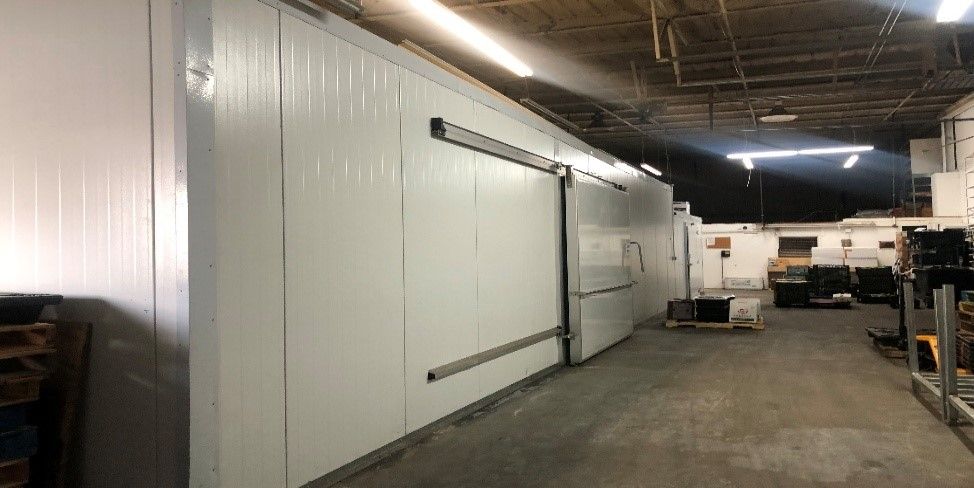 The Back of A Building with A Warehouse Door and A Loading Dock.
