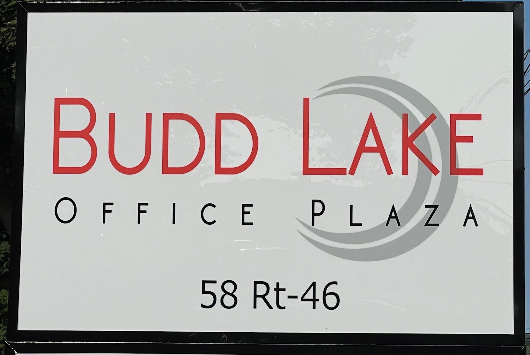 A budd lake office plaza sign that is outside