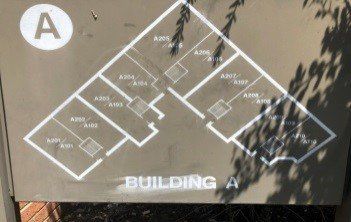 Floor plan of Building A with room numbers in a white layout on a brown background.
