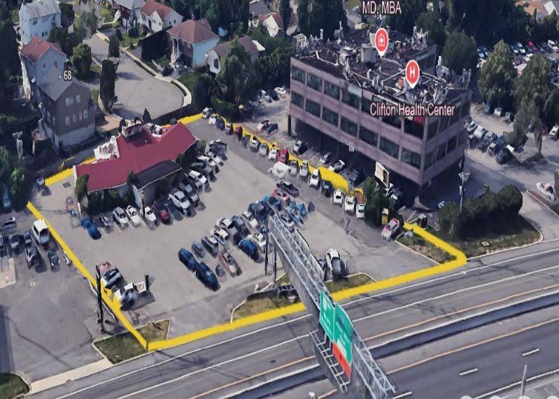 An aerial view of a parking lot next to a highway
