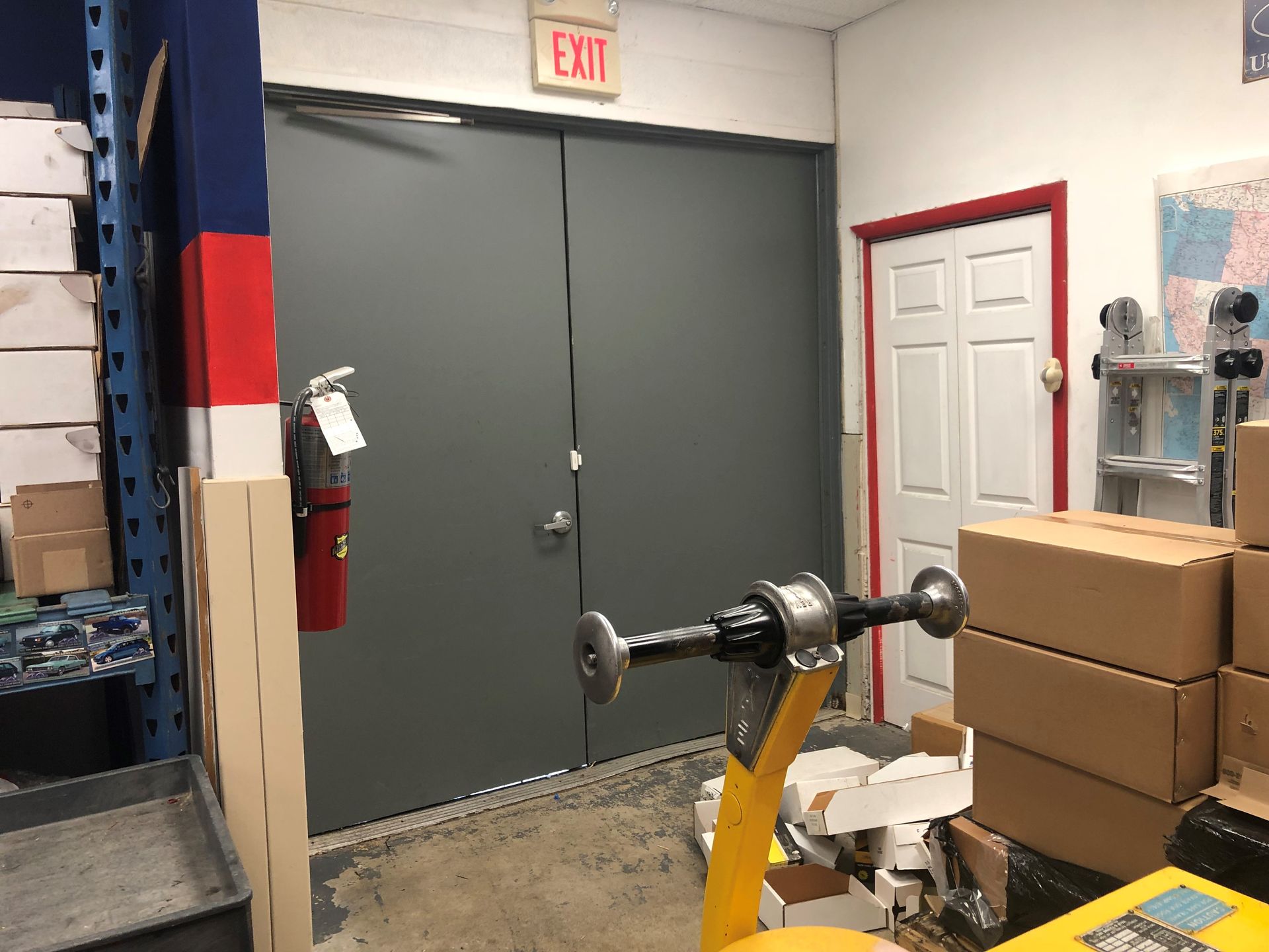 A warehouse with a large exit sign on the wall.