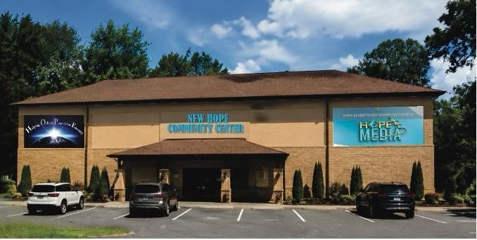 Closer conceptual rendering of the New Hope Community Center building exterior with entrance canopy and landscaping.