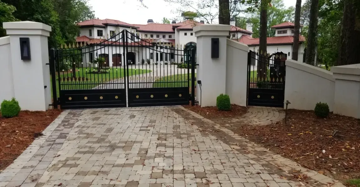 a large white house with a black gate in front of it