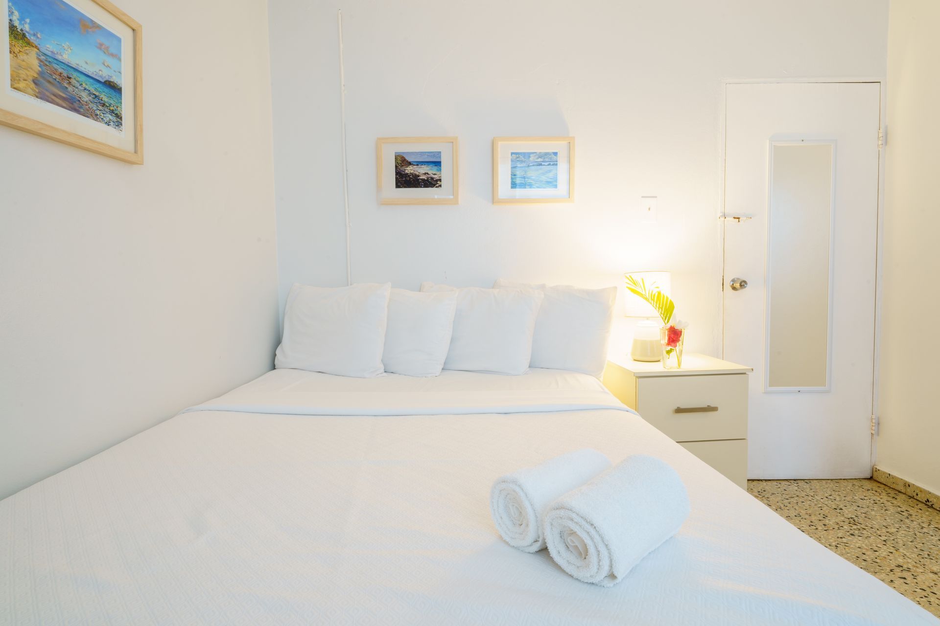 A bedroom with a bed and two towels on it.