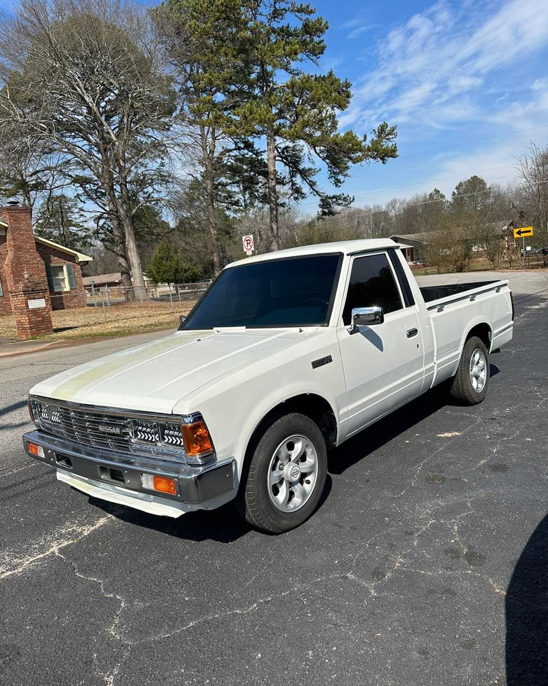 A white truck is parked on the side of the road.