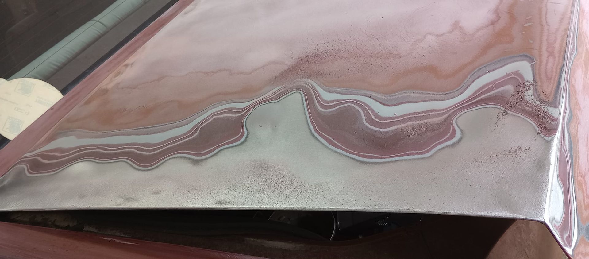 A close up of a piece of metal sitting on top of a table.