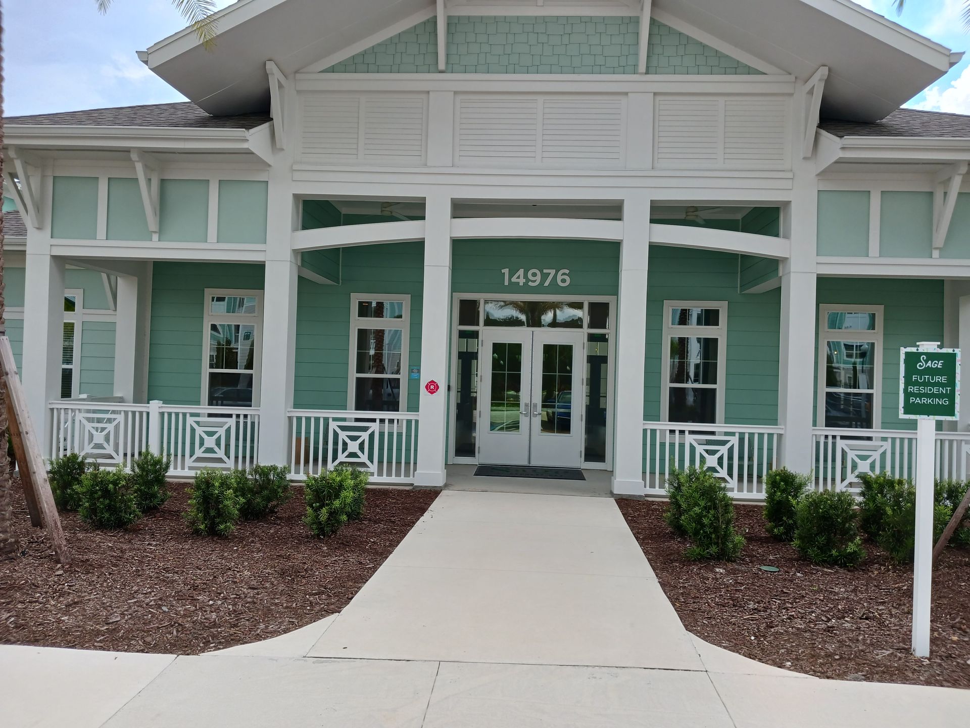A green and white building with the number 14976 on the front