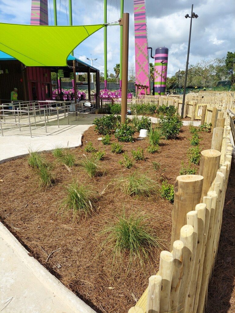 A wooden fence surrounds a lush green garden.-Crowders Landscaping