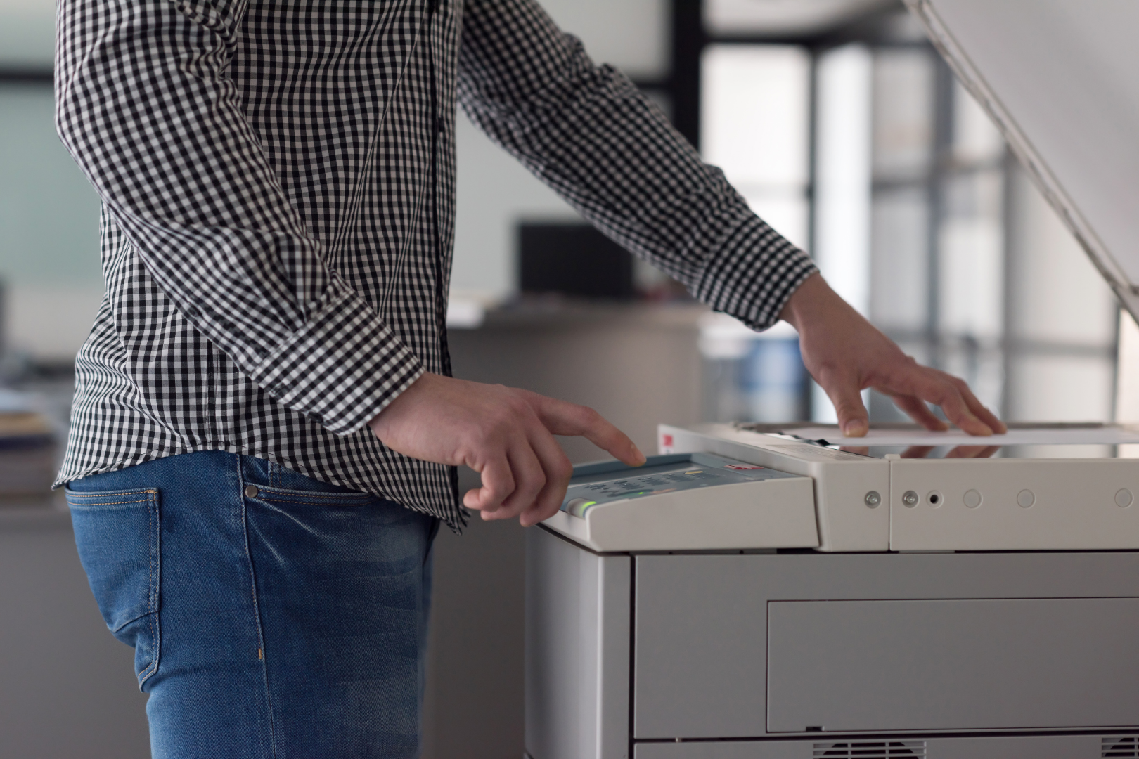 Person operating a copier or printer in an office setting