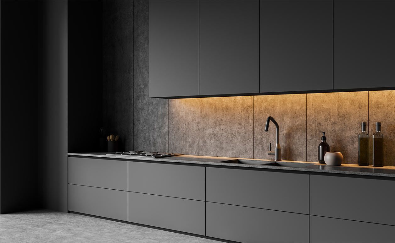 Modern minimalist kitchen with dark cabinets, concrete counter, warm under-cabinet lighting, and sink accessories
