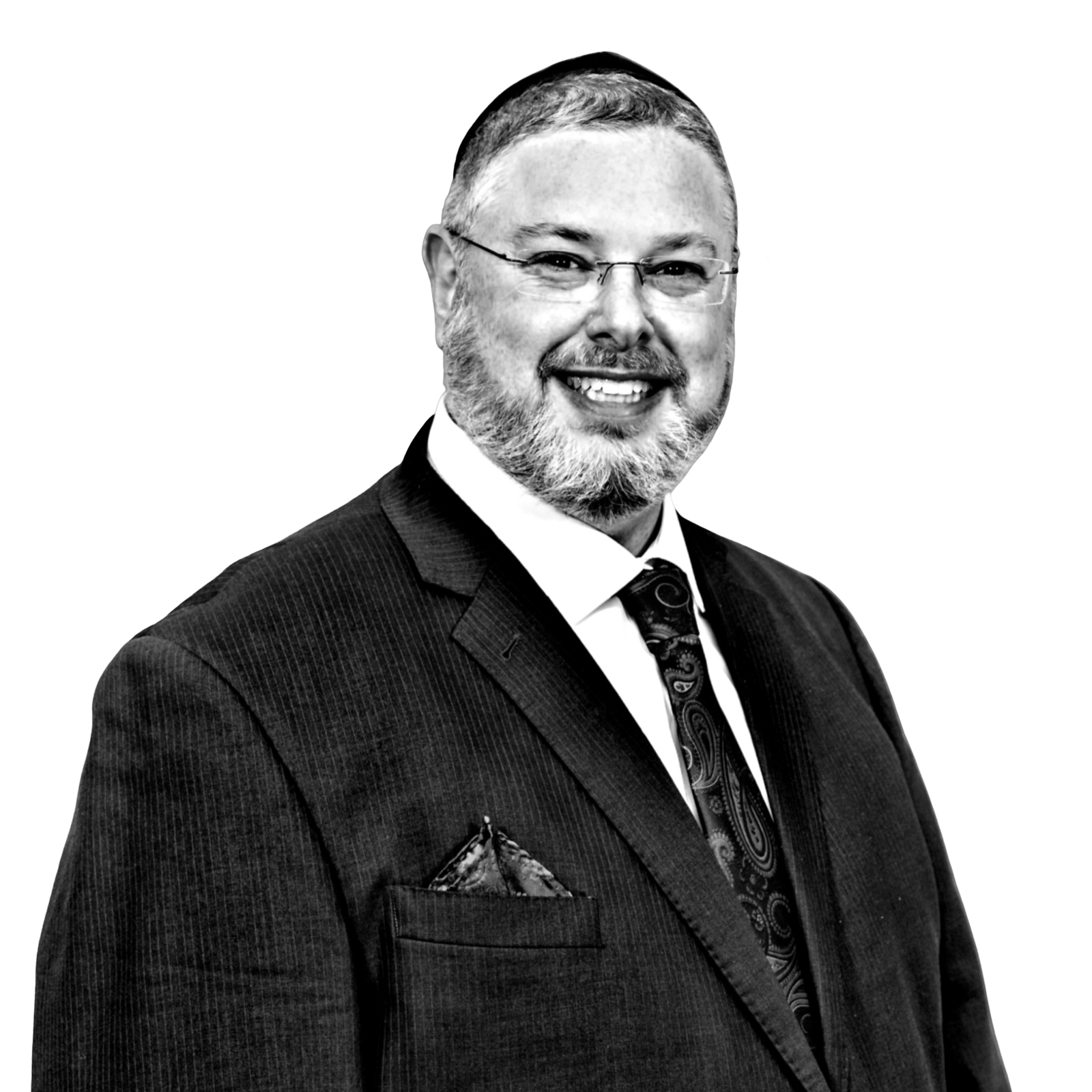A man in a suit and tie is smiling in a black and white photo.