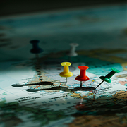 Colored pushpins marking locations on a world map
