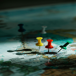 Colored pushpins marking locations on a world map