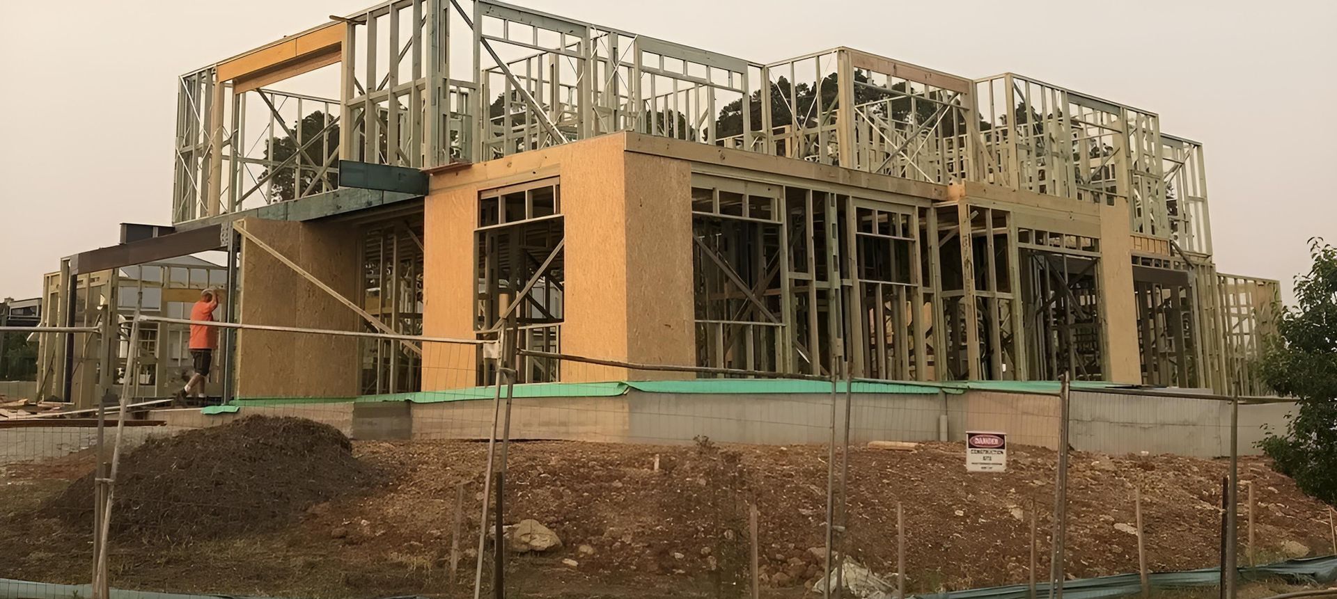 A Large Building is Being Built in the Middle of a Dirt Field — East Maitland Building In Lake Macquarie, NSW