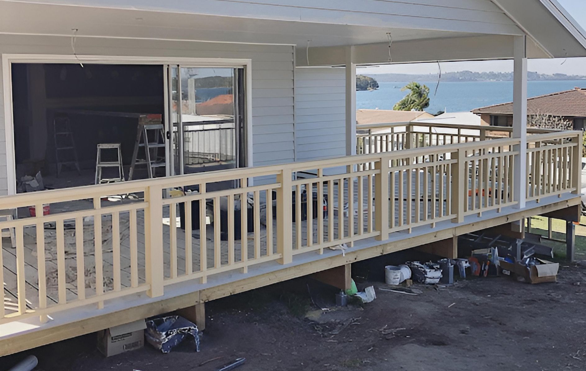 A House With a Balcony and a Bucket of Paint in Front of It — East Maitland Building In Port Stephens, NSW