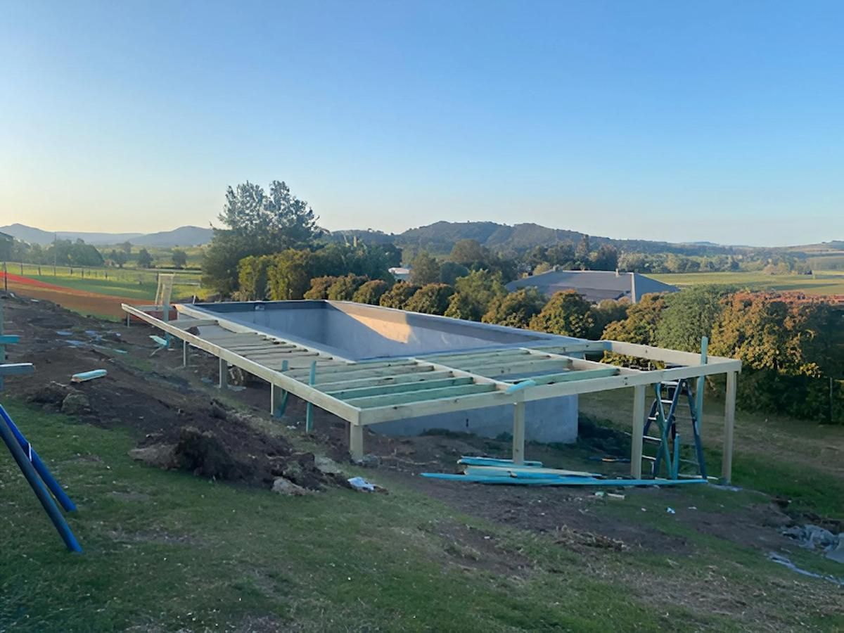 A Large Swimming Pool is Being Built in the Middle of a Grassy Field — East Maitland Building In Port Stephens, NSW
