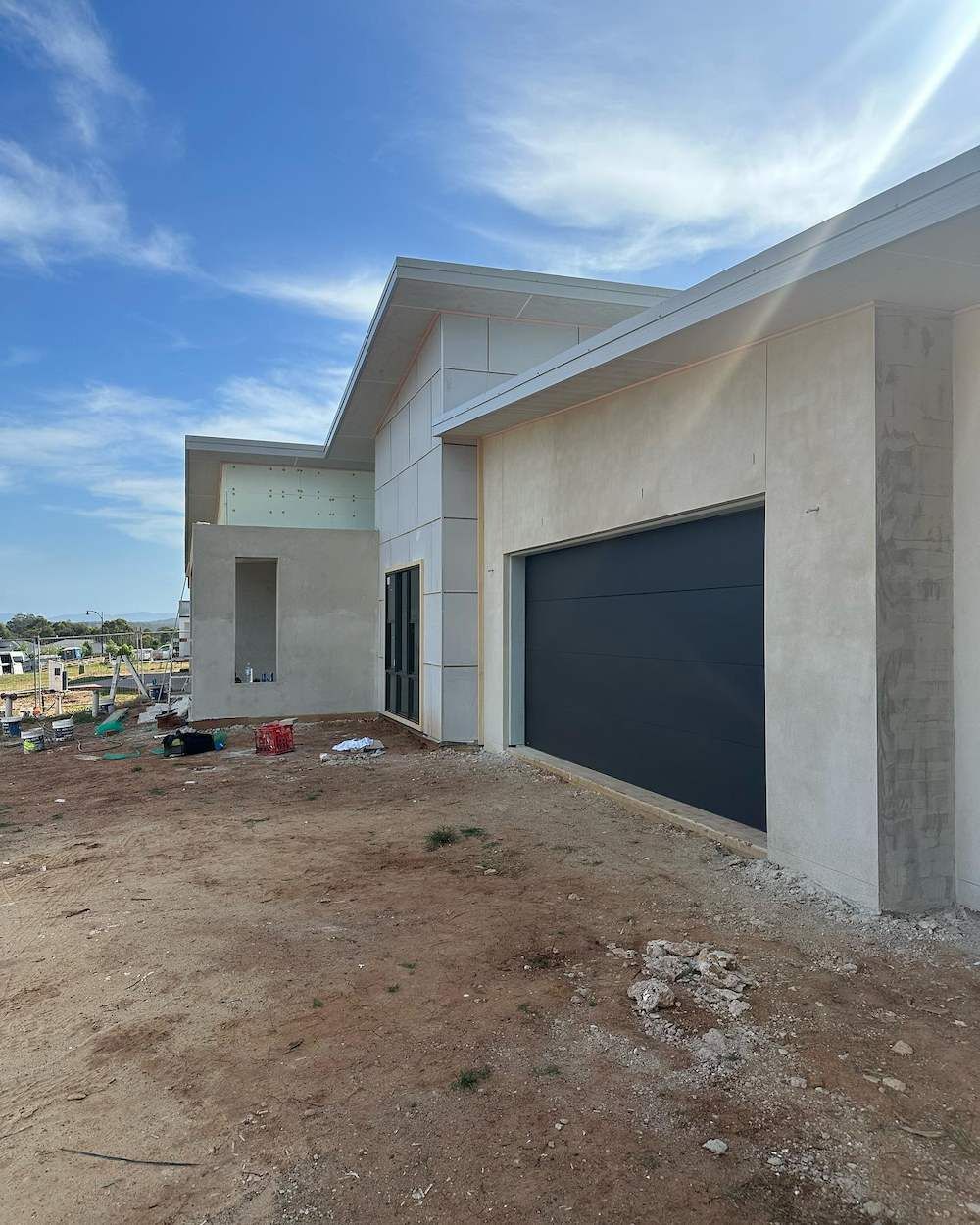 A House Under Construction With a Black Garage Door — East Maitland Building In Branxton, NSW