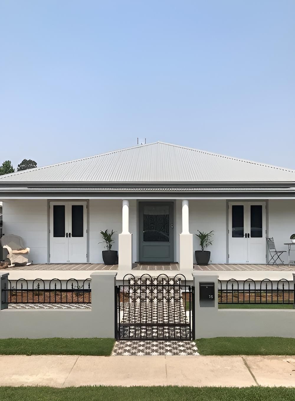 A White House With a Fence in Front of It — East Maitland Building In Tenambit, NSW