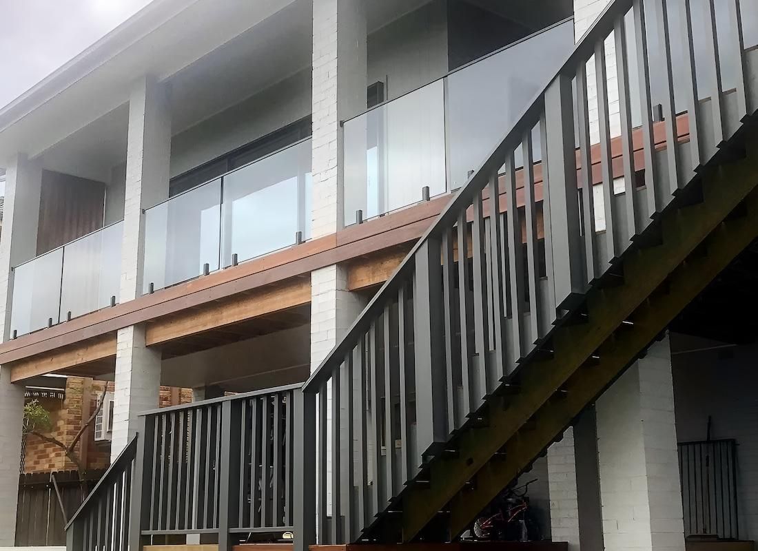Stairs Leading Up to a Balcony With a Glass Railing — East Maitland Building In Newcastle, NSW