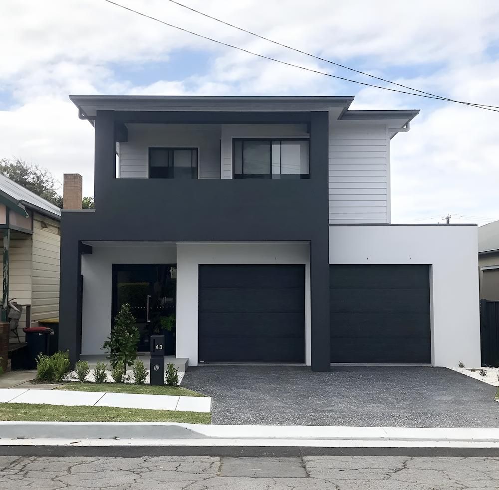 A White and Black House With a Black Garage Door — East Maitland Building In Tenambit, NSW