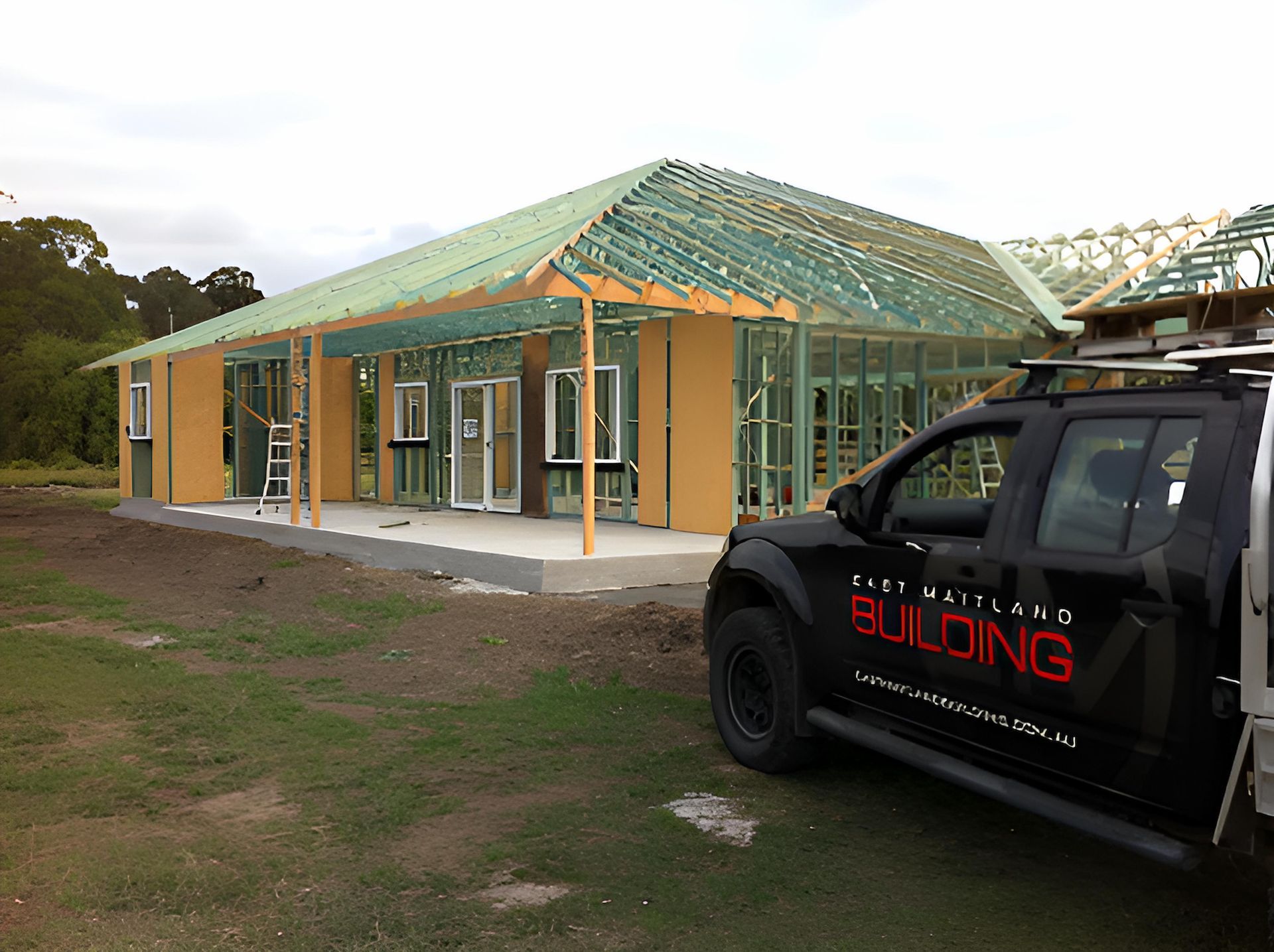 A Black Building Truck is Parked in Front of a House Under Construction — East Maitland Building In Lake Macquarie, NSW