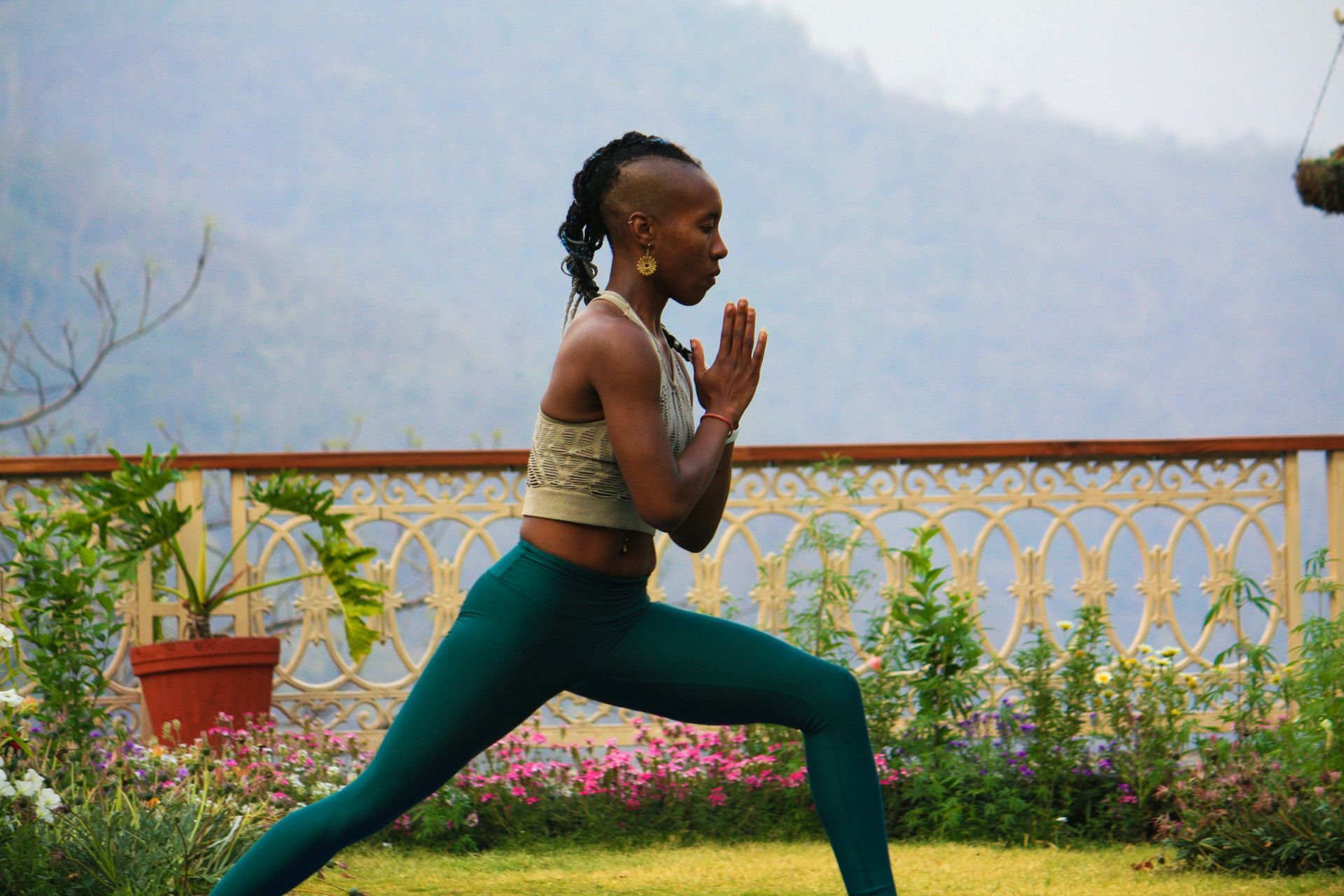 A woman engages in yoga in a garden.