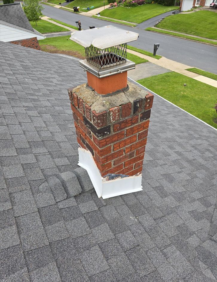 Photo of chimney on the roof of a house in need of repair.