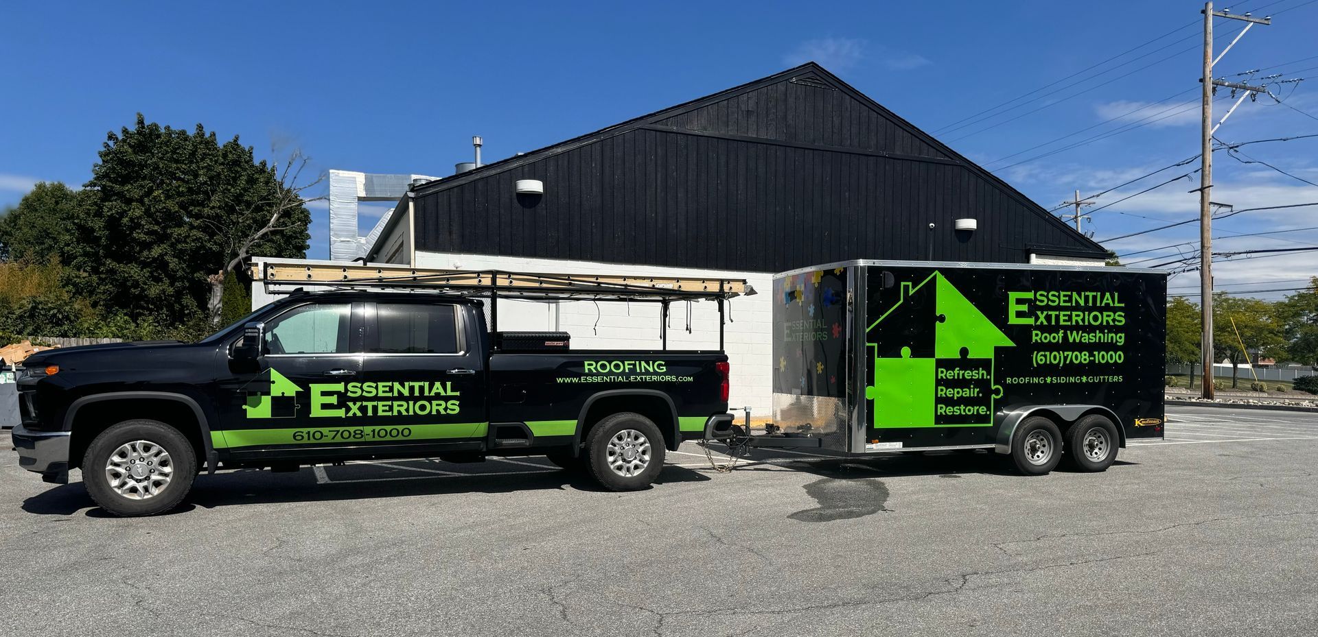 A truck and trailer are parked in front of a building.