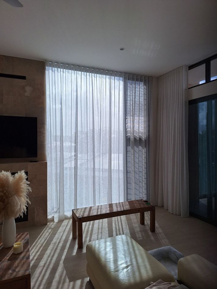 CUSTOM MADE CURTAINS IN SHEER FABRIC FITTED TO THE CEILING AND FALLING TO THE FLOOR, INSTALLED ON THE SUNSHINE COAST