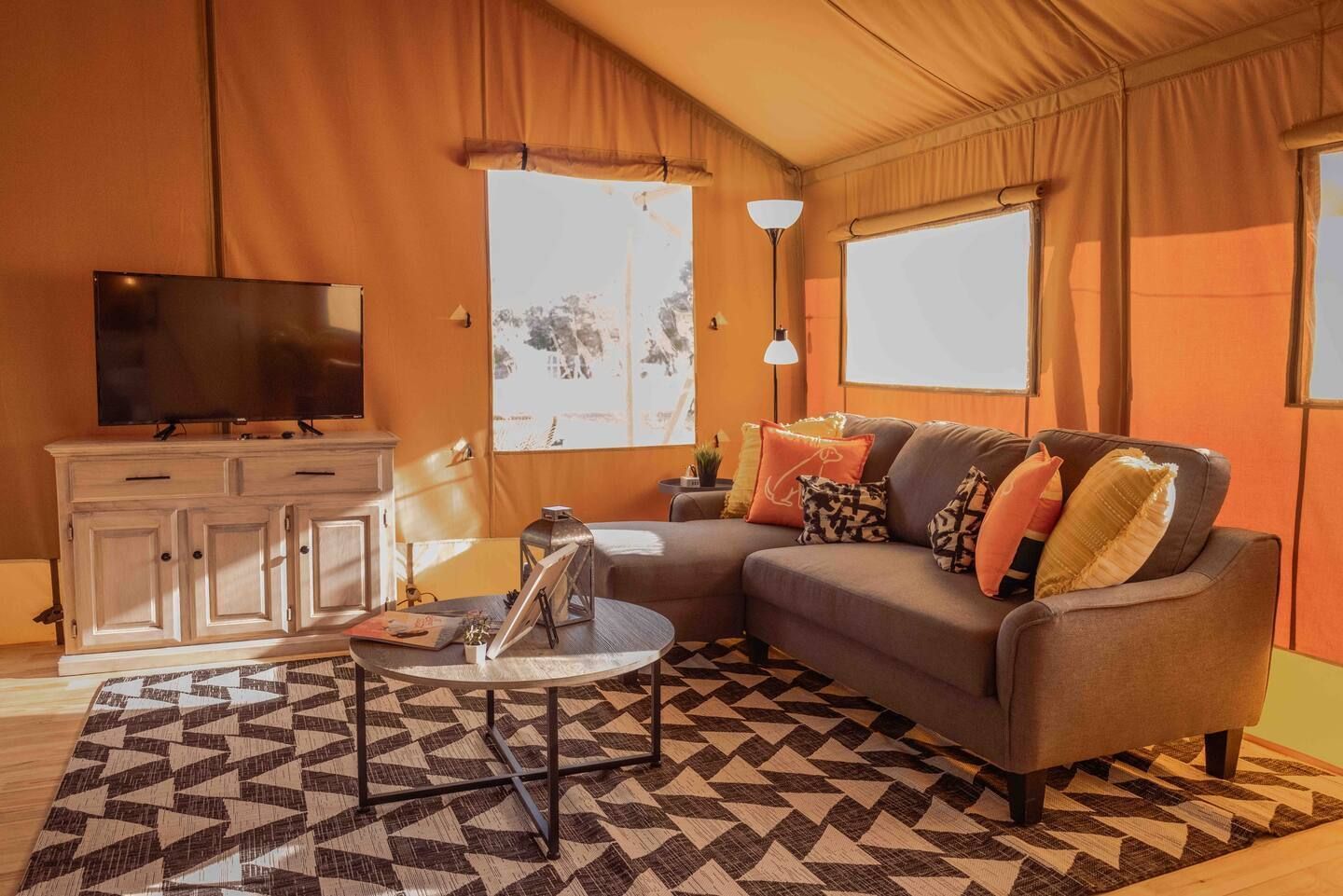 A living room with a couch , table , and television.
