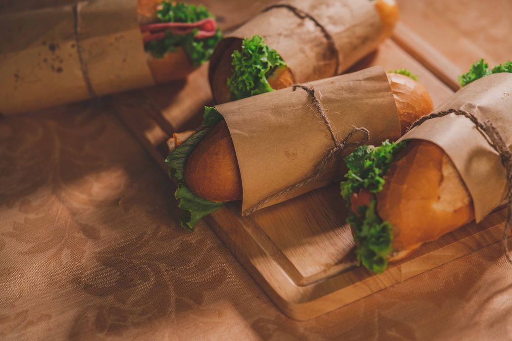 Chocolate-dipped cones filled with strawberries and greens on a wooden board
