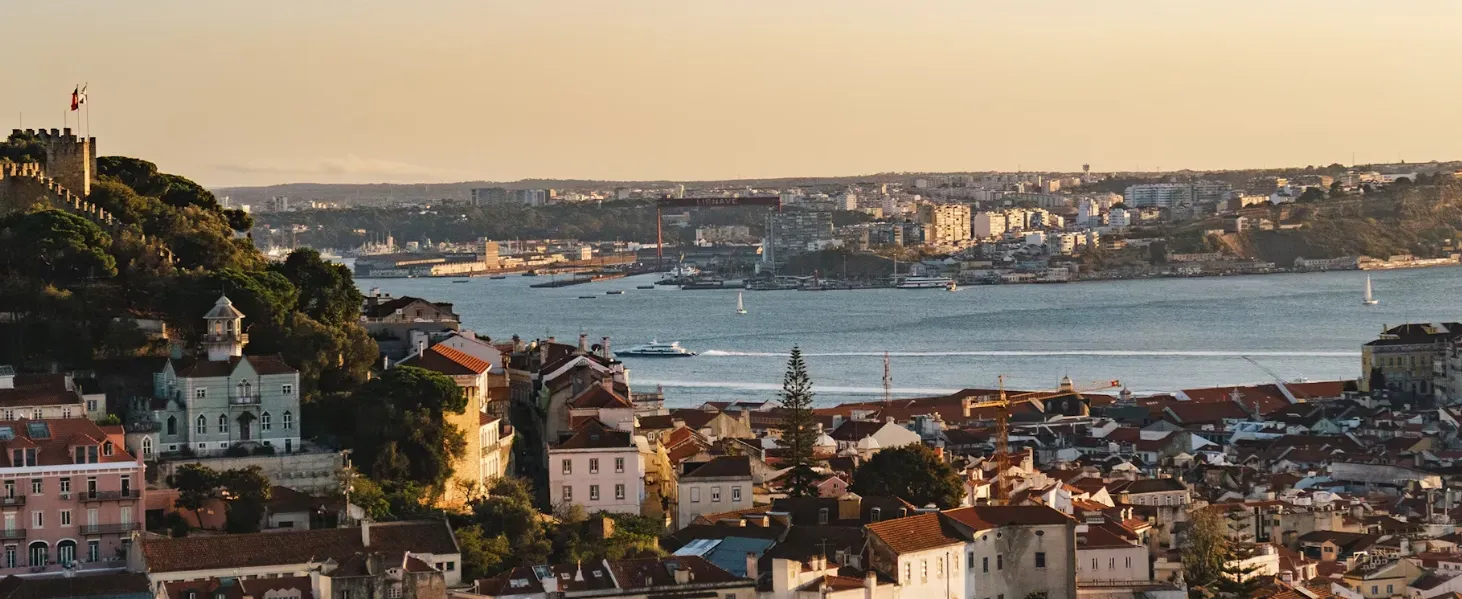 An aerial view of a city with a large body of water in the background