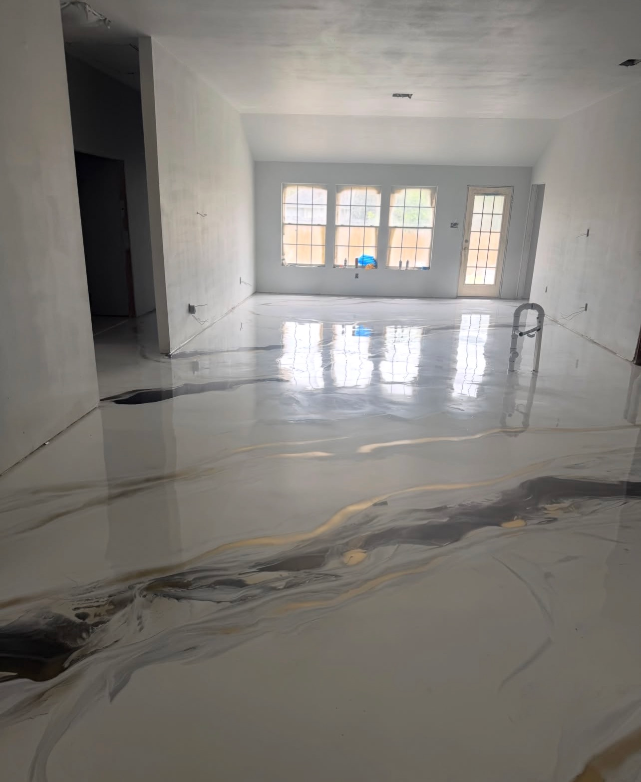Empty white room with glossy marble floor and large windows, reflecting light