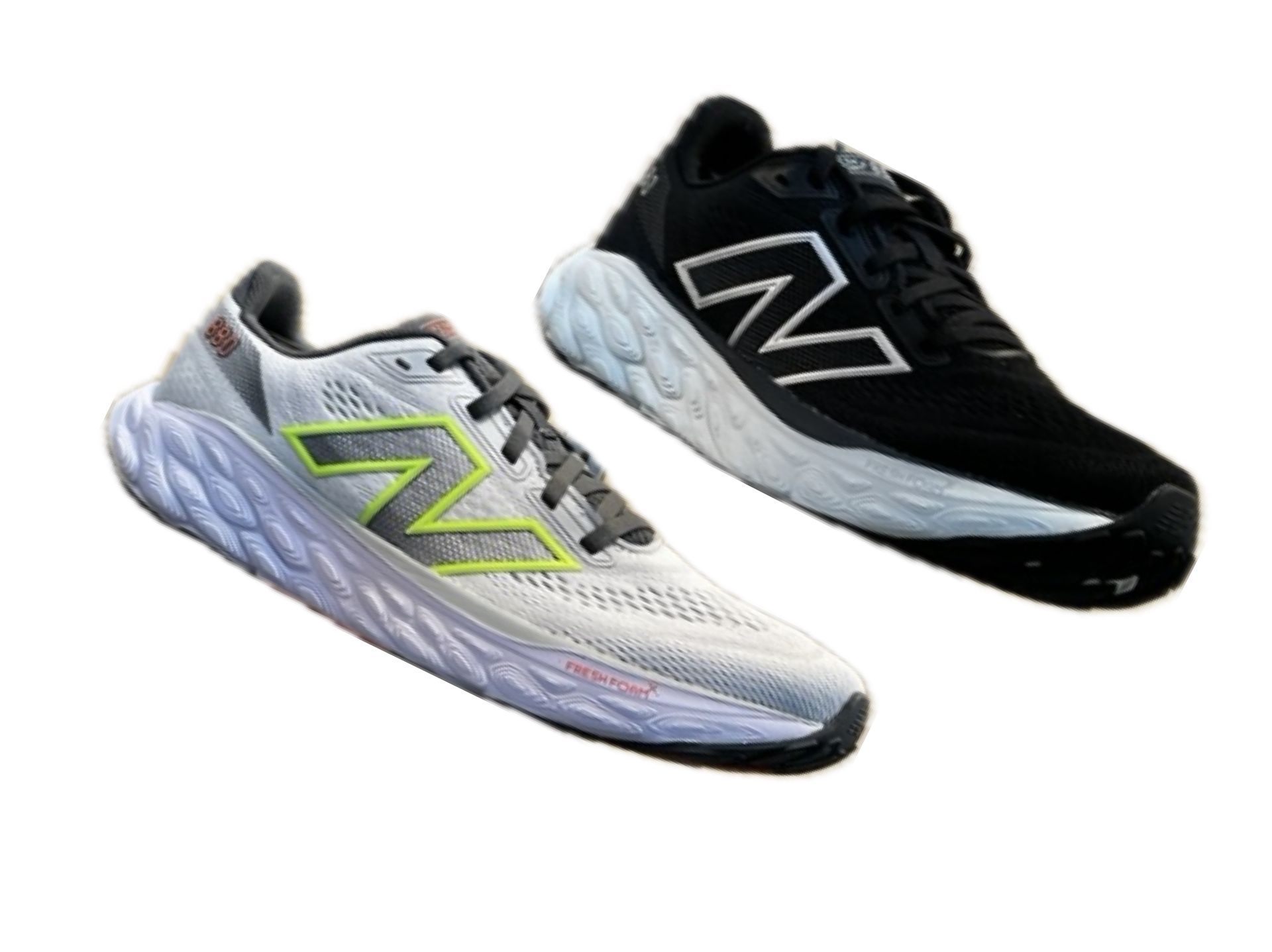 A pair of new balance running shoes are sitting next to each other on a white background.