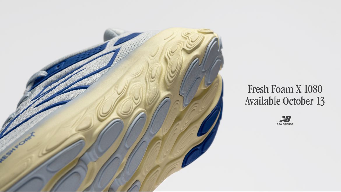 A close up of the bottom of a blue and white shoe.
