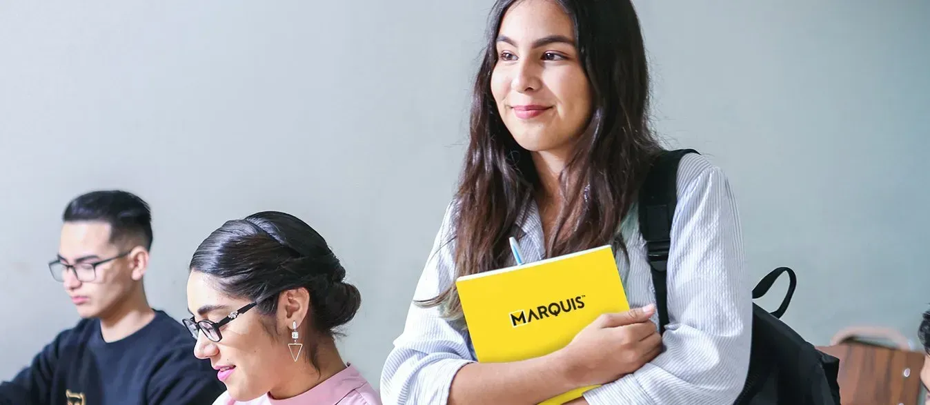 Person holding a yellow-and-black book titled “Your English”
