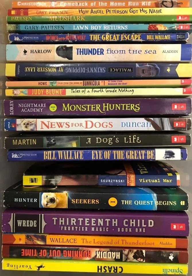 Stack of children's books with titles visible: