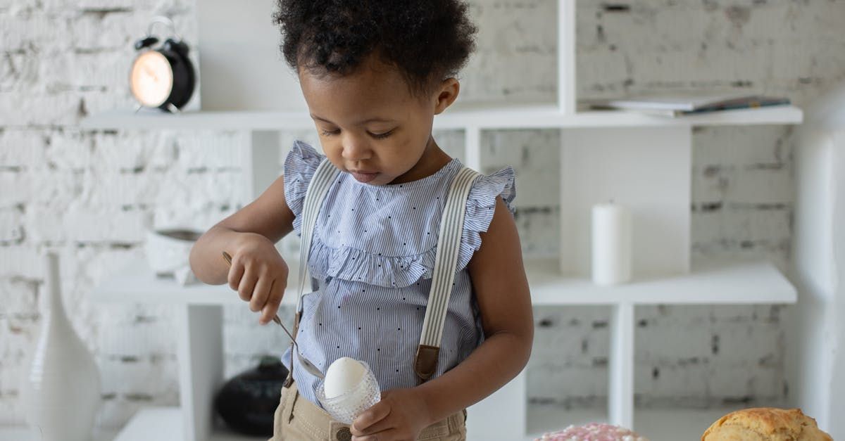 Kid scooping egg with spoon
