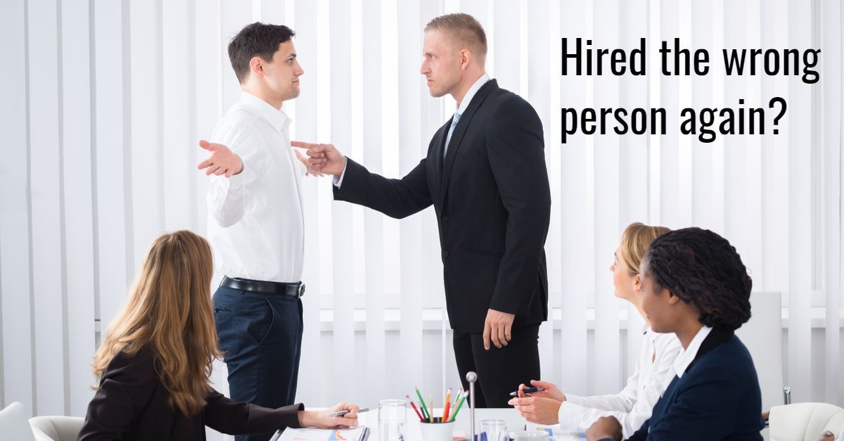 A male office worker pointing his finger a t a male colleague in anger.