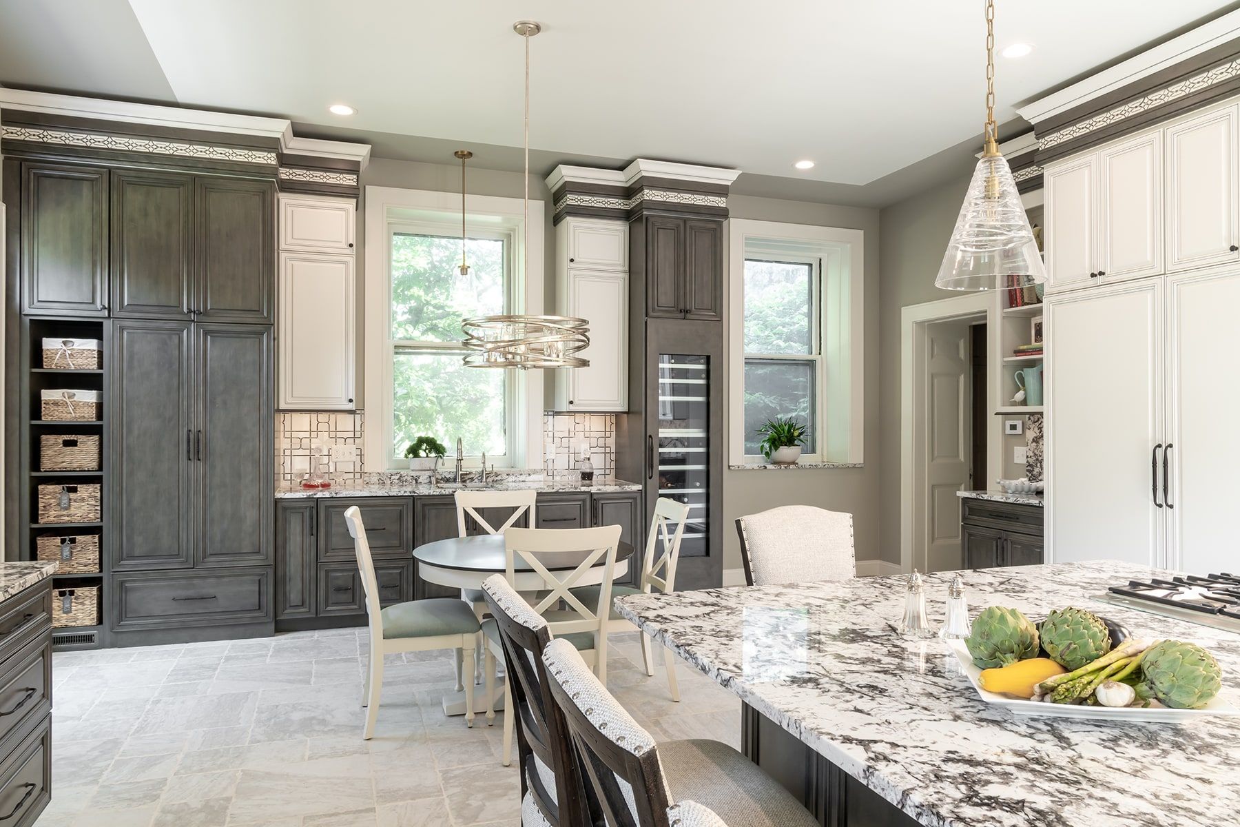 A kitchen with a large island and a dining table.