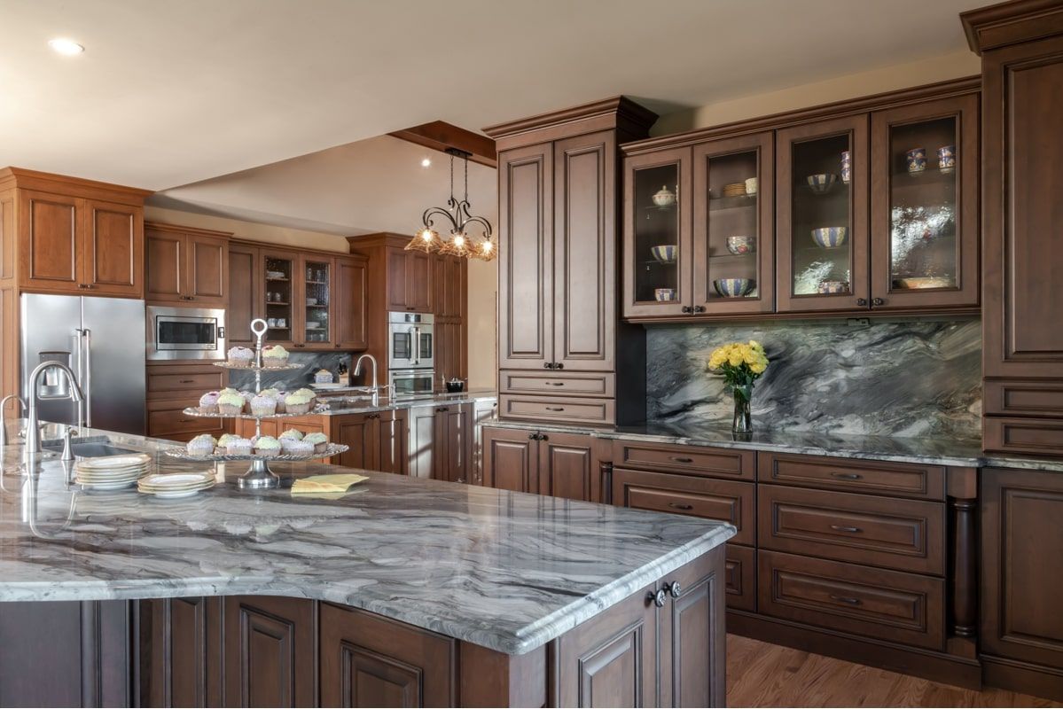 A kitchen with wooden cabinets and granite counter tops.