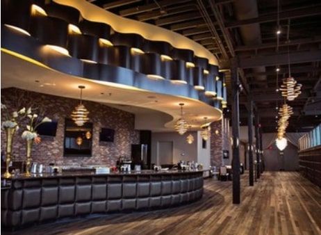 A large room with a bar in the middle of it