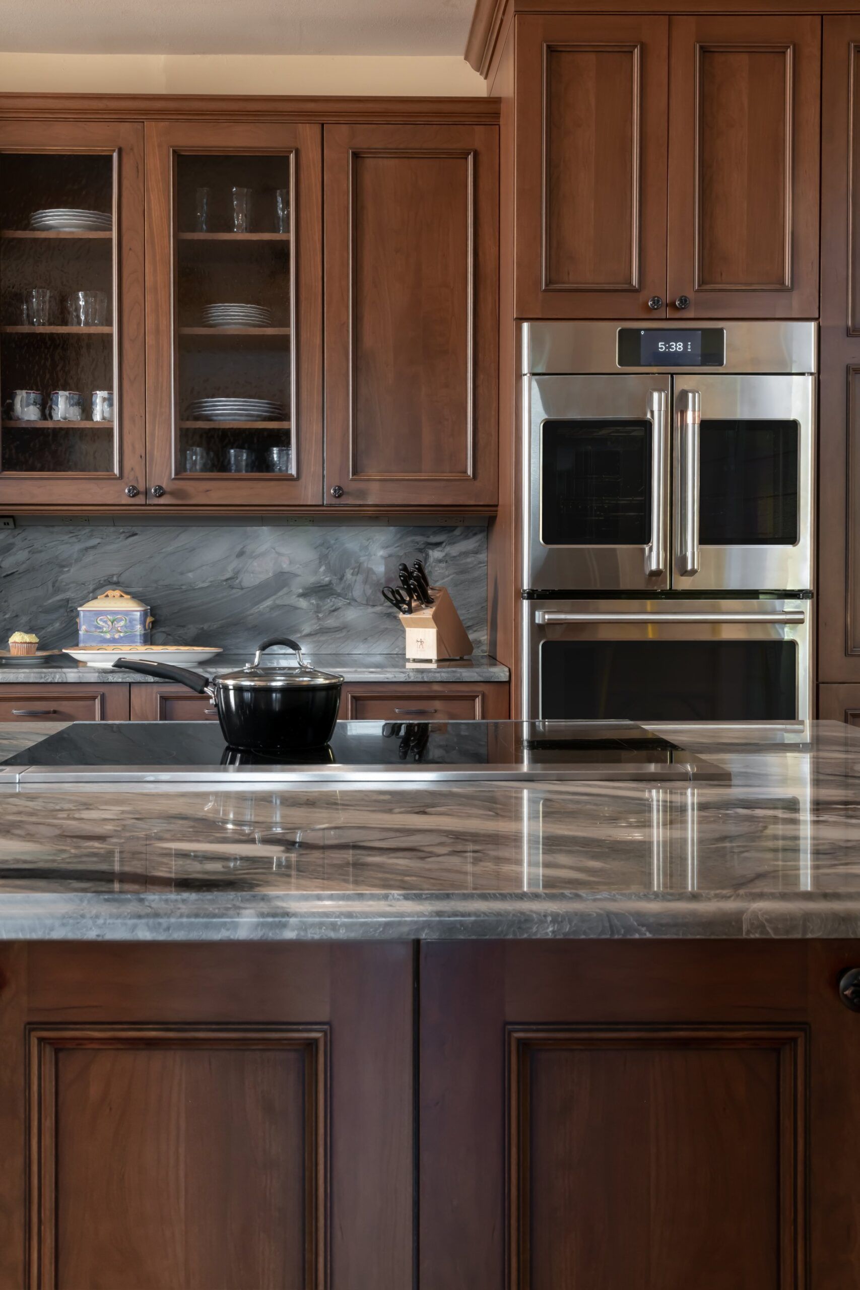 A kitchen with wooden cabinets and stainless steel appliances.