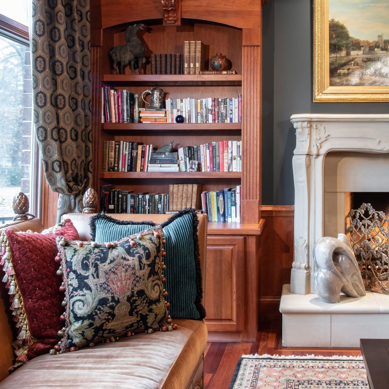 A living room with a fireplace and bookshelves