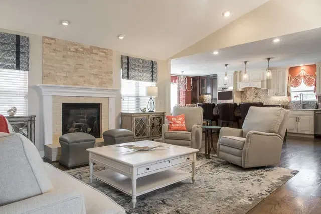 A living room filled with furniture and a fireplace.