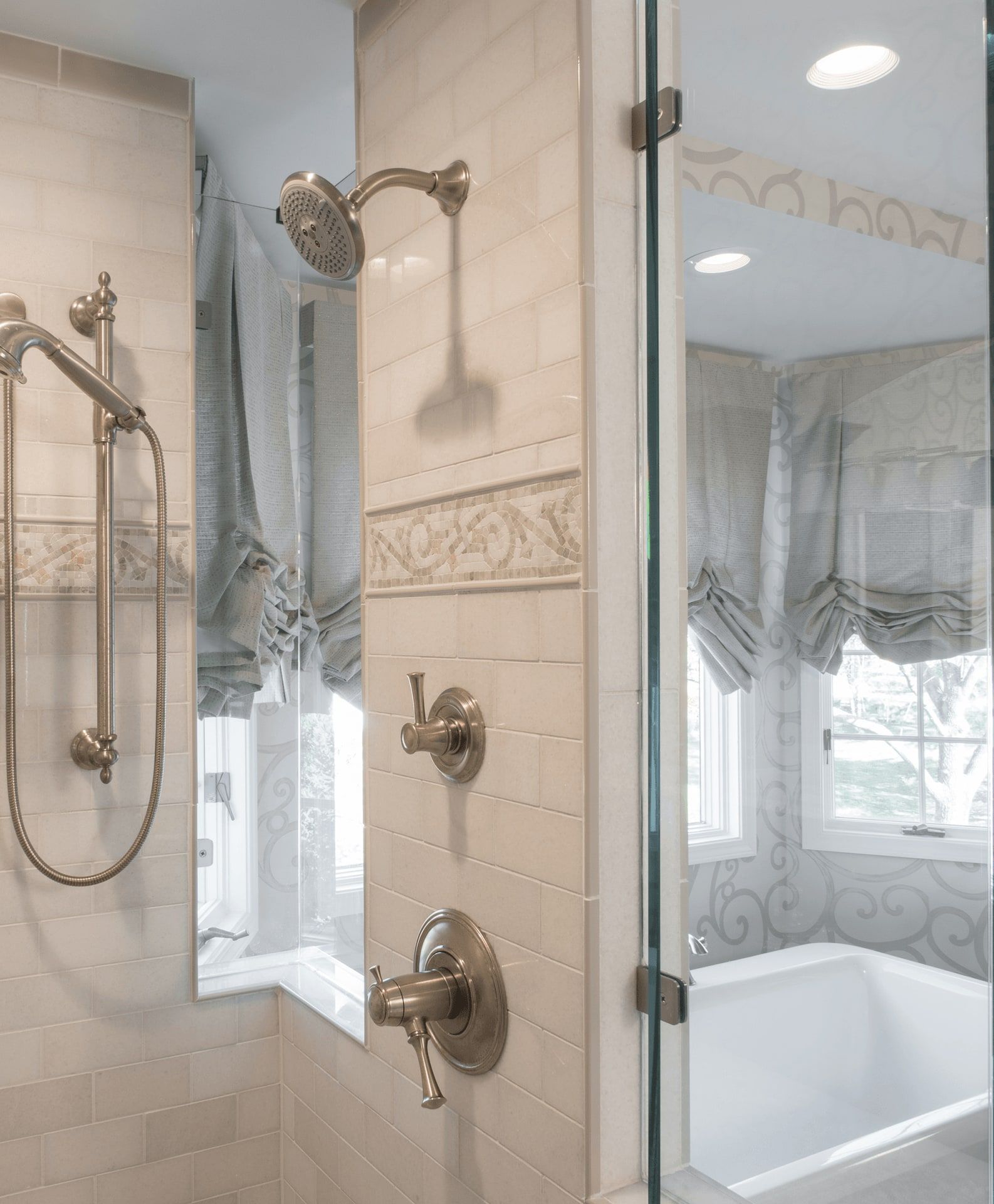 A bathroom with a tub , shower , and mirror.